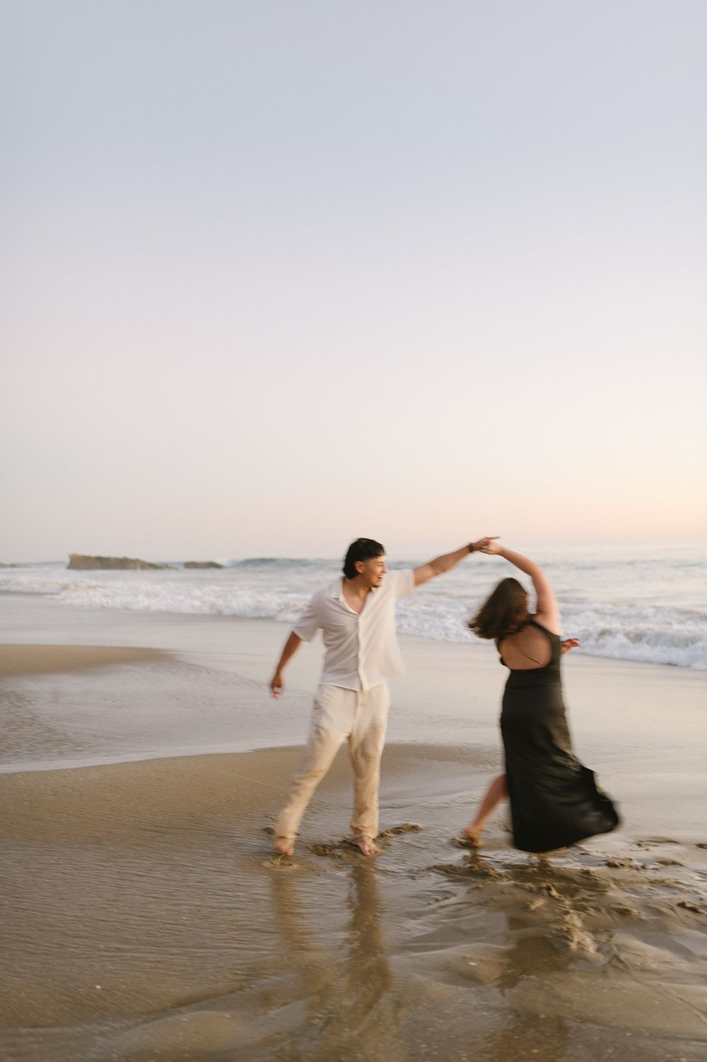 Couple dancing in Laguna Beach for engagement photos in Orange County