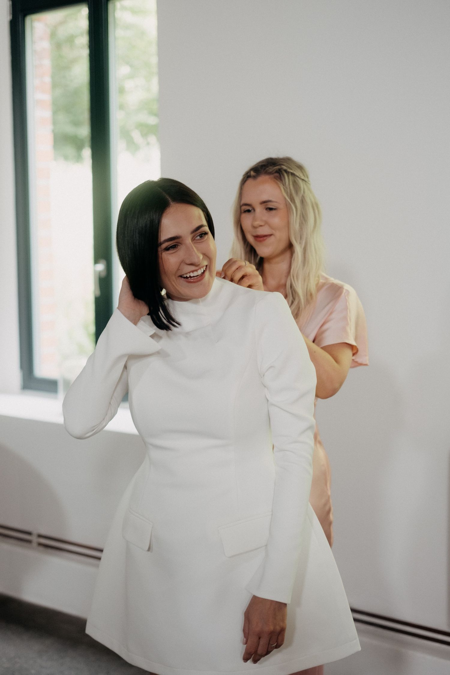 Candid moments captured in bright white room showing joyful interactions.