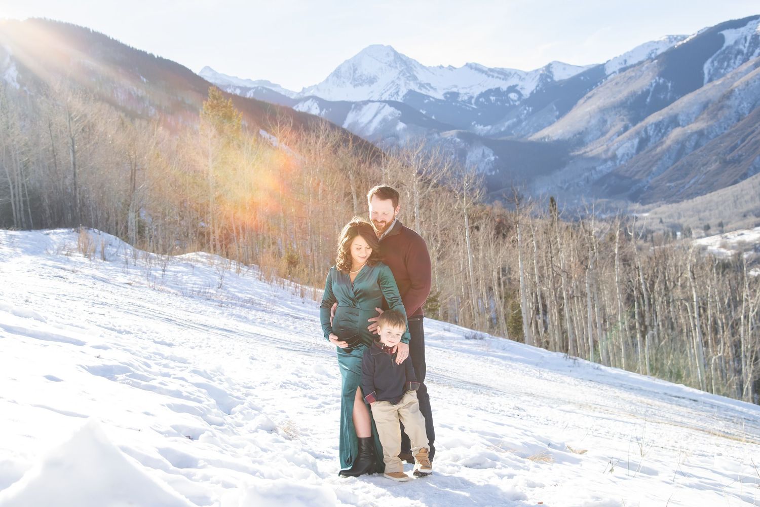 Winter family photos in Snowmass Colorado with snow and mountain peaks