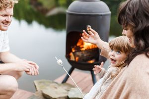 Hands passing sparklers and sharing magical moments during an outdoor evening gathering.