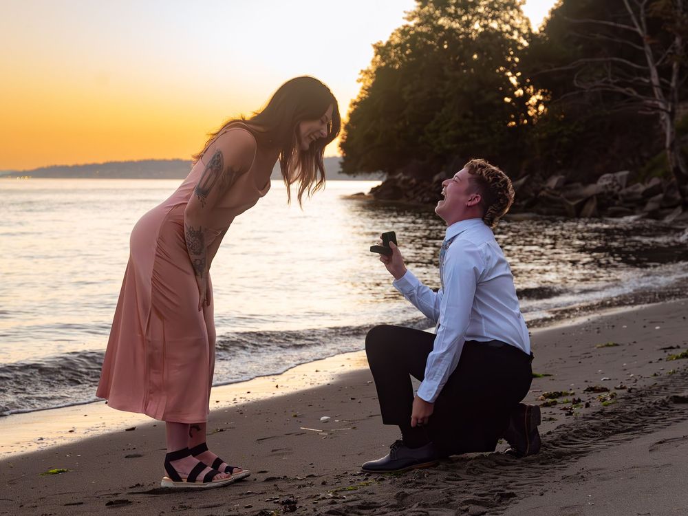 Romantic couple sharing intimate moments on a sandy beach during a beautiful golden hour sunset.