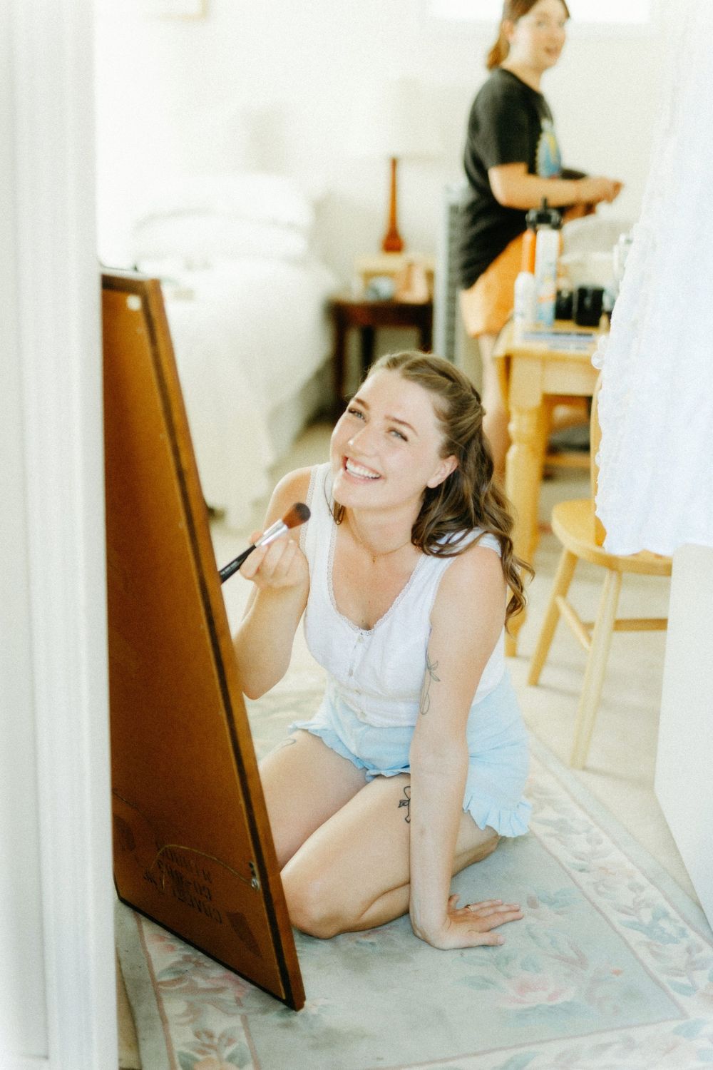 Getting ready scene with makeup application in bright indoor setting.