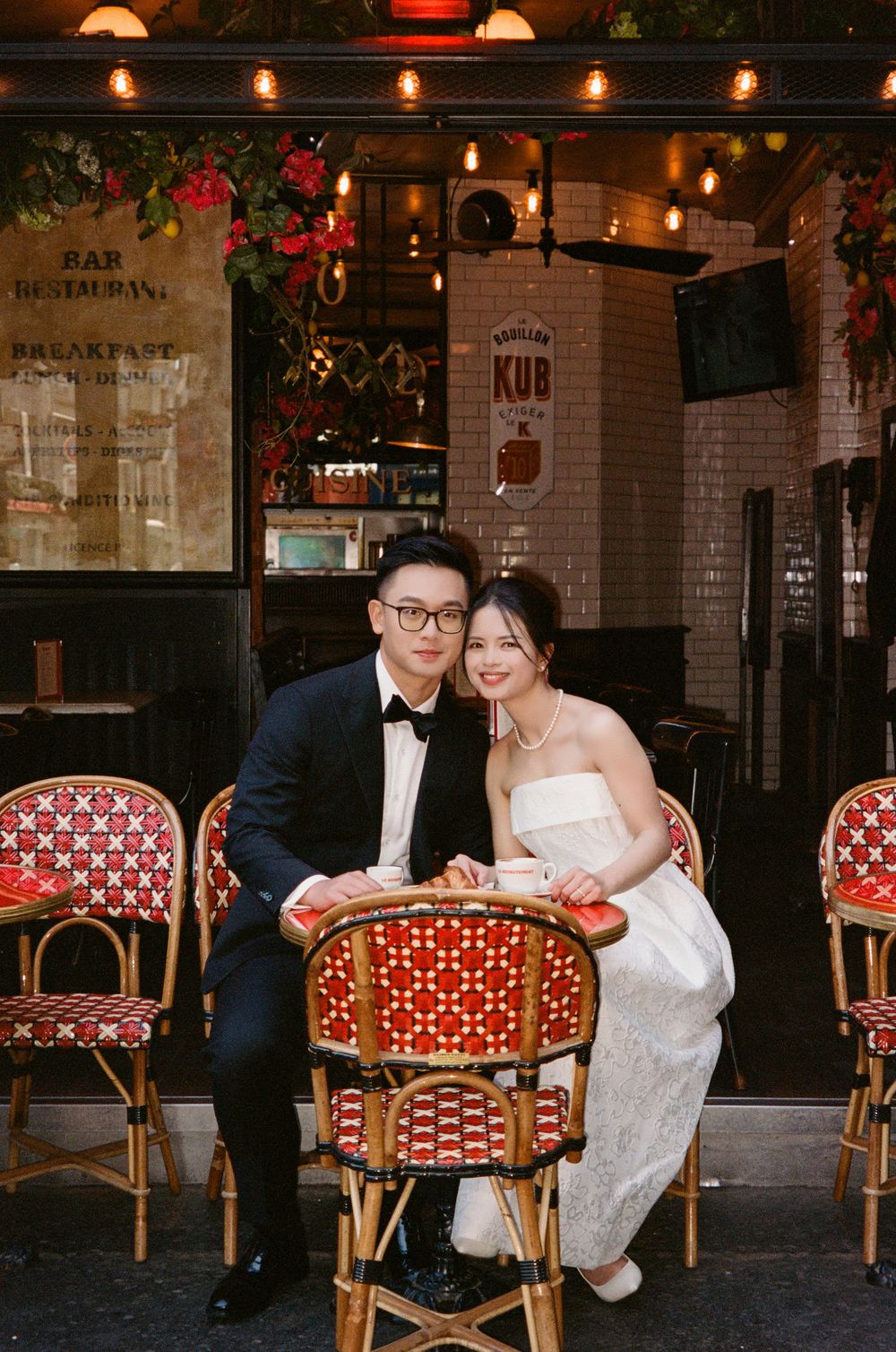 Romantic evening at a French bistro with red and white decor and ambient lighting.