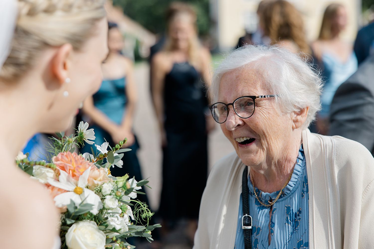 A candid moment of joyful laughter and celebration at an elegant wedding reception.
