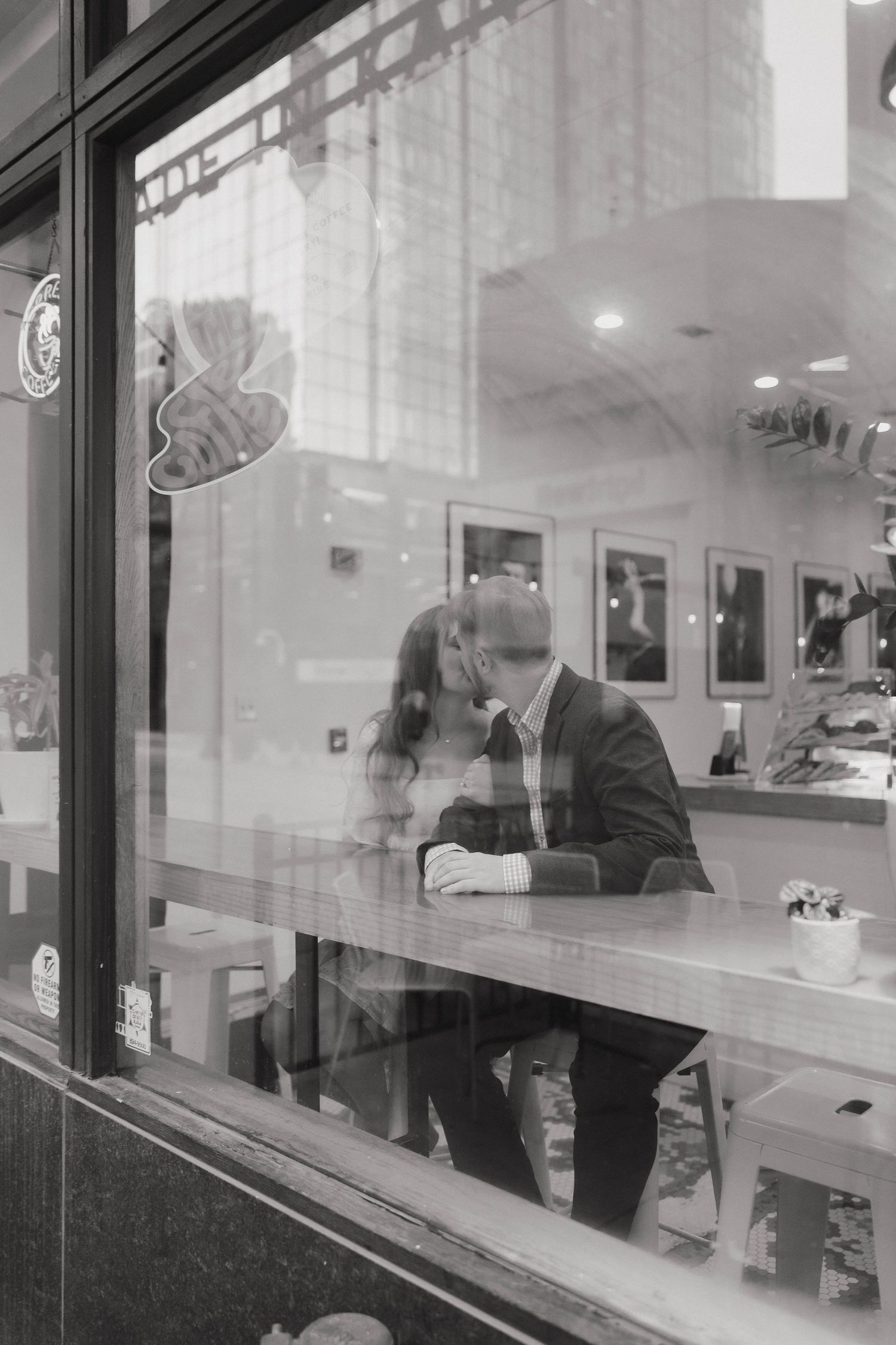 People work behind glass windows at a bank or office building teller counter.