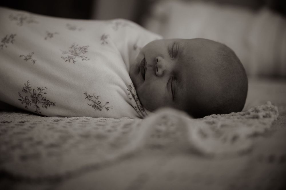 Black and white newborn photography in Fort Worth, Texas posed naturally in studio