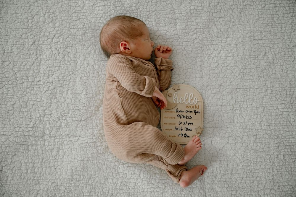In home newborn photography session in Fort Worth Texas with newborn baby boy in neutral browns and cream blanket