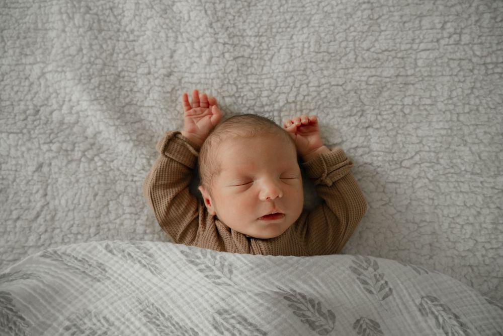 DFW newborn photographer capturing natural moments at home with gentle posing
