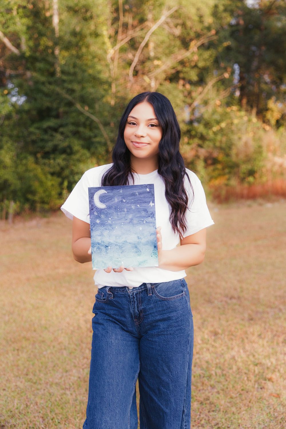 A series of outdoor photos showing someone in a white t-shirt and jeans against an autumn background.