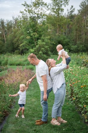 A playful sequence of candid family moments in a lush garden setting with wildflowers and greenery.