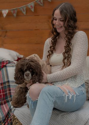 Indoor lifestyle photos with brown dog on plaid blanket.