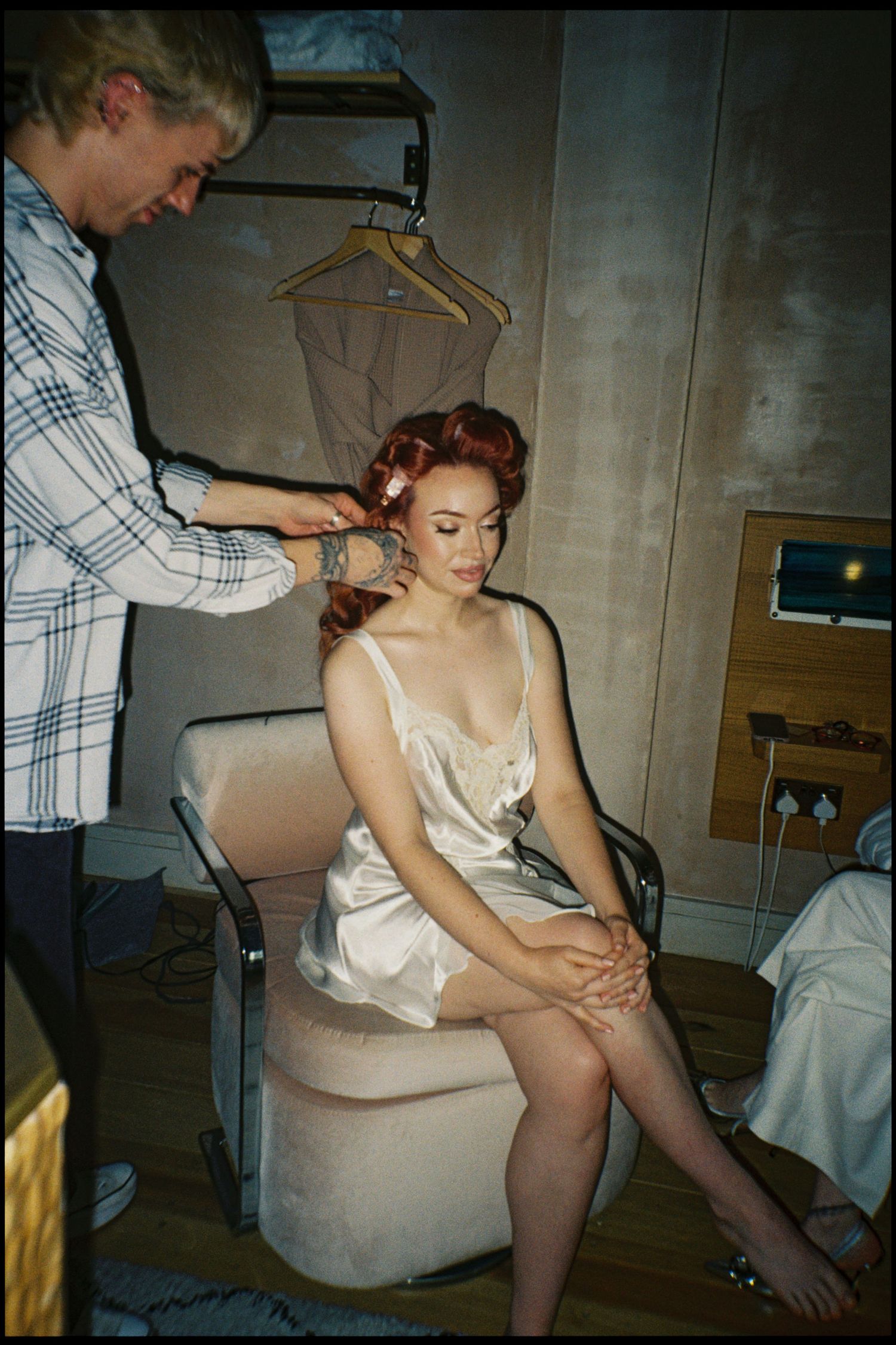 A series of vintage photographs showing someone getting ready in a white slip dress and stockings.