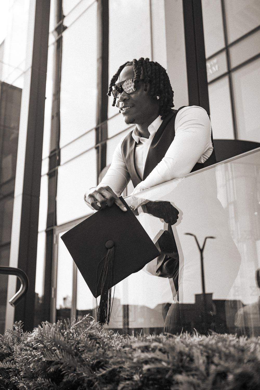 Black and white photo series showing a person in white top and dark pants sitting in various poses on a porch with shrubs.