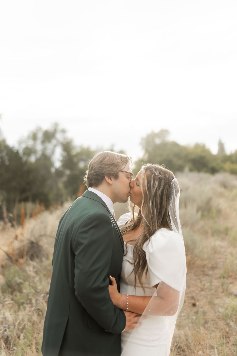 Intimate outdoor wedding portrait of bride and groom sharing a quiet moment in Utah
