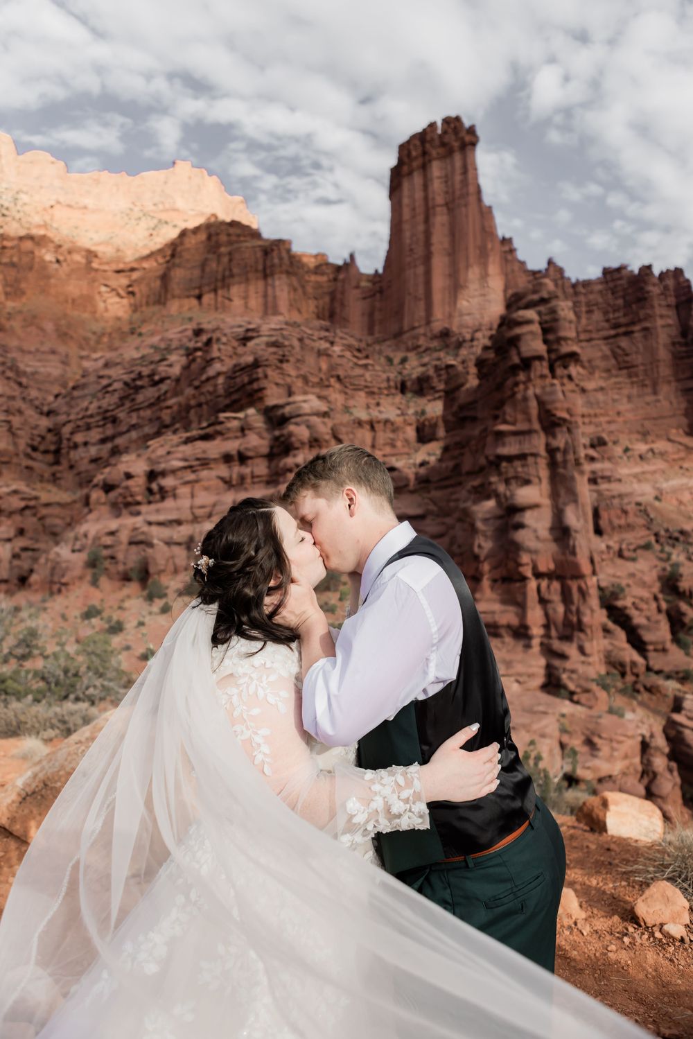 Bride and groom sharing a kiss during a red rock elopement in Utah