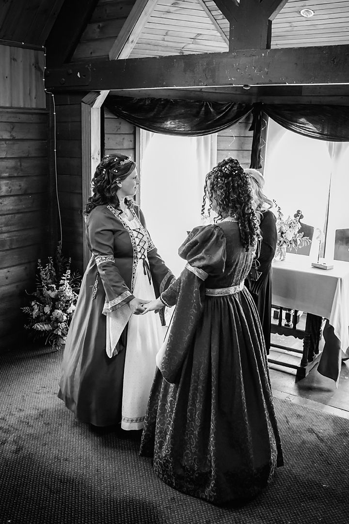 Black and white wedding preparation photos showing formal dresses and gowns in an intimate indoor setting.