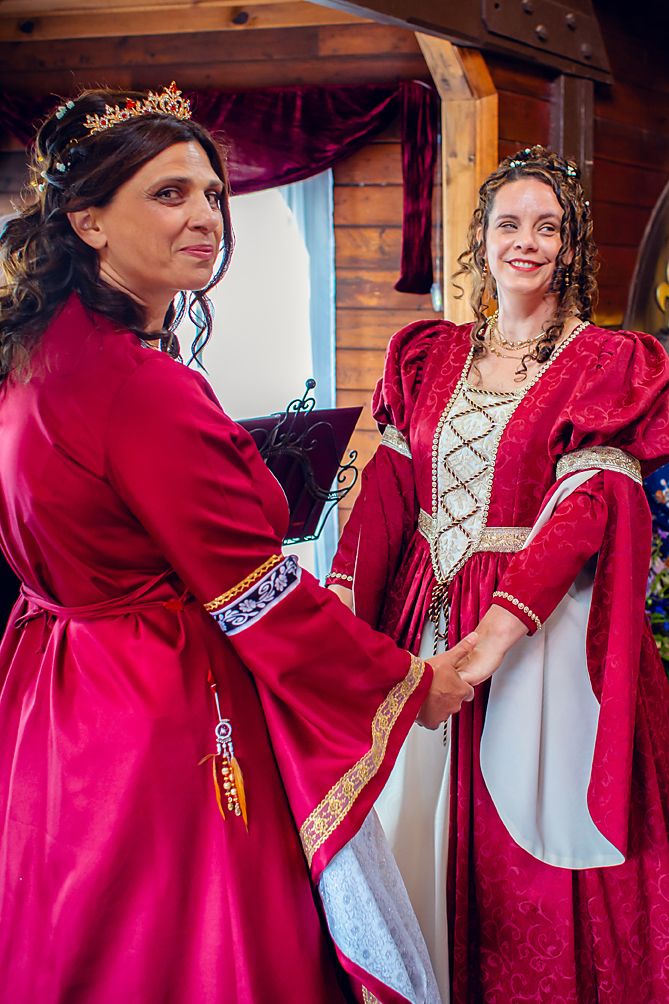 A series of photos showing someone in a medieval-style red velvet gown with gold trim posing near a wooden wall.