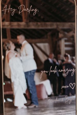 Romantic wedding message overlay on blurred dance scene in rustic venue.
