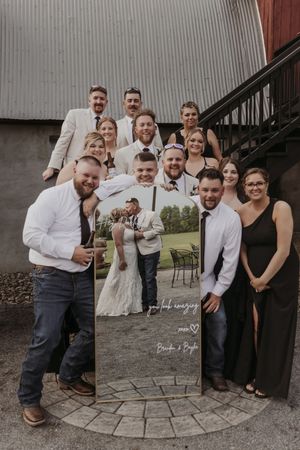 A group photo session with family members in formal attire posing on a curved stone patio.