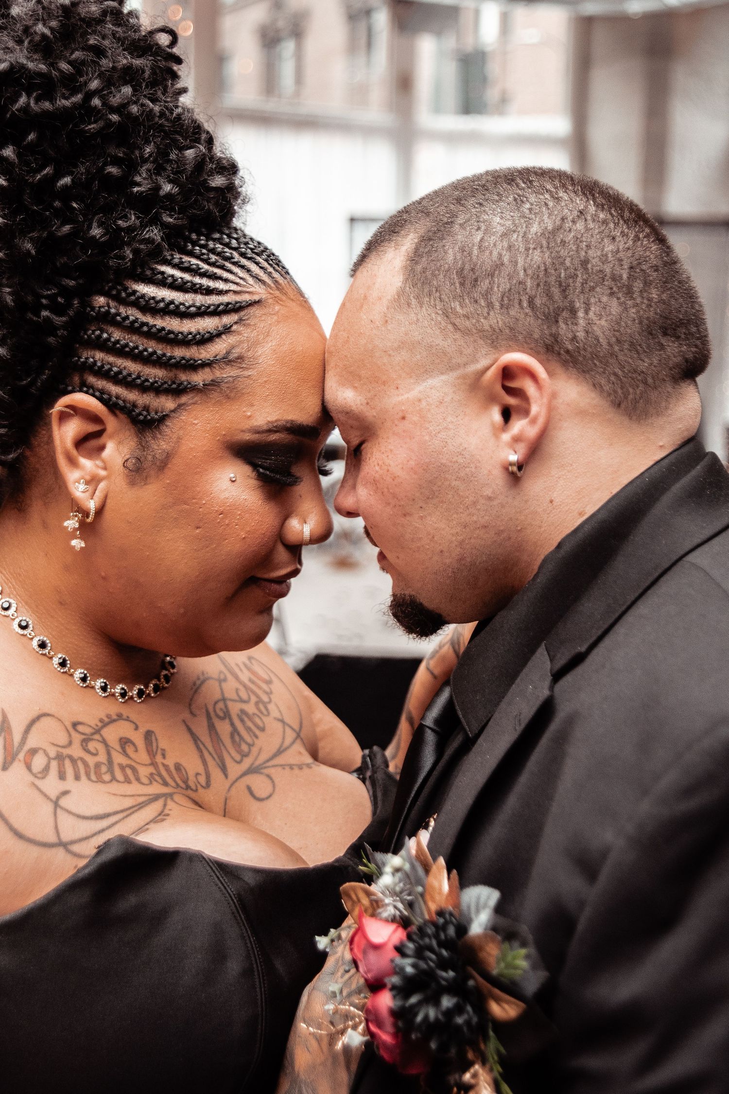 A romantic sequence of wedding photos showing tender moments between a couple in black attire with floral details.