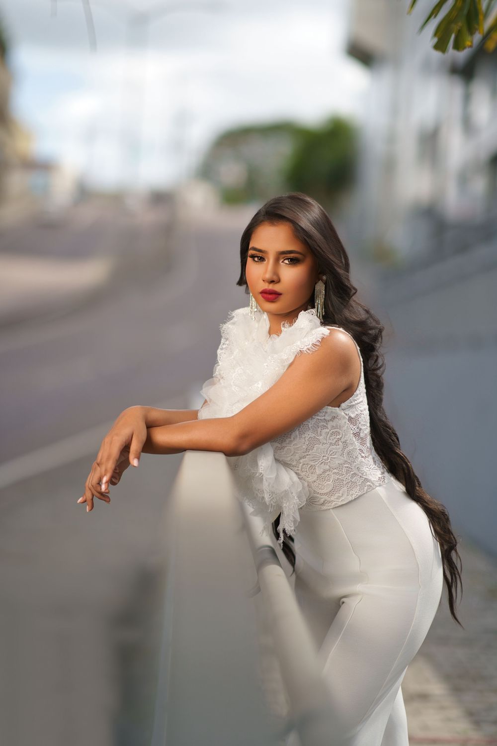 Elegant bridal fashion photo series showing a white formal dress against an urban background.