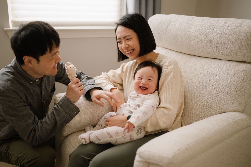 A family sharing joyful moments together on a comfortable white sofa.