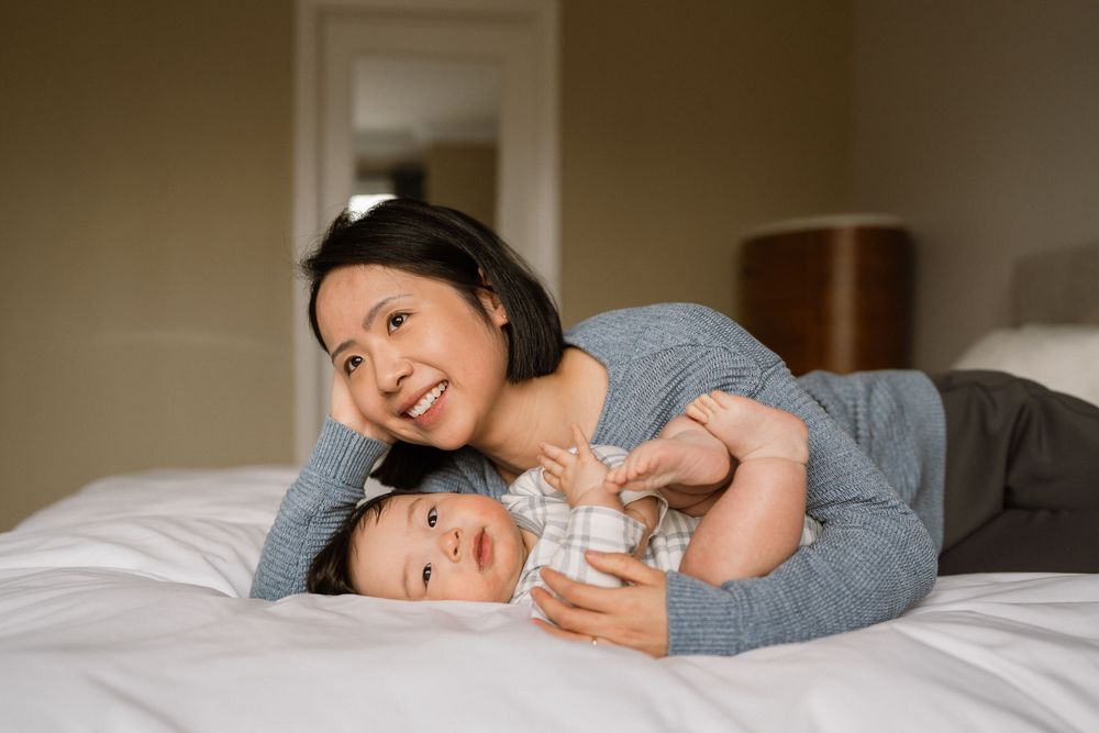 Tender family moments shared while relaxing on comfortable bedding.