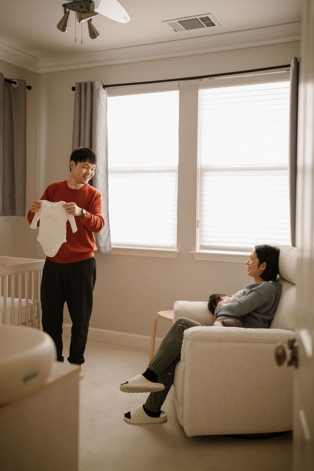 Playful sequence of people relaxing on a white couch in a bright living room.