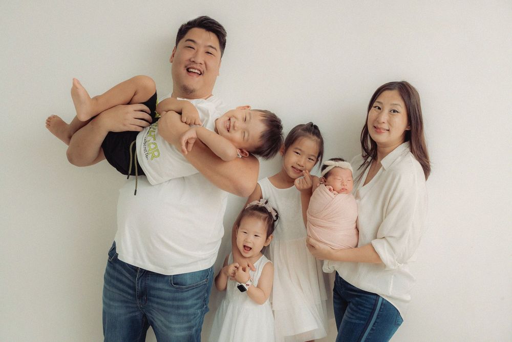 Family photo series showing playful and candid moments together against white wall.