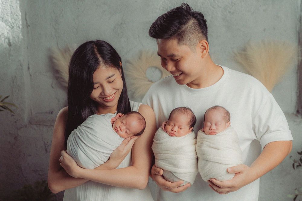 Family portrait series against concrete wall showing tender moments with twins.