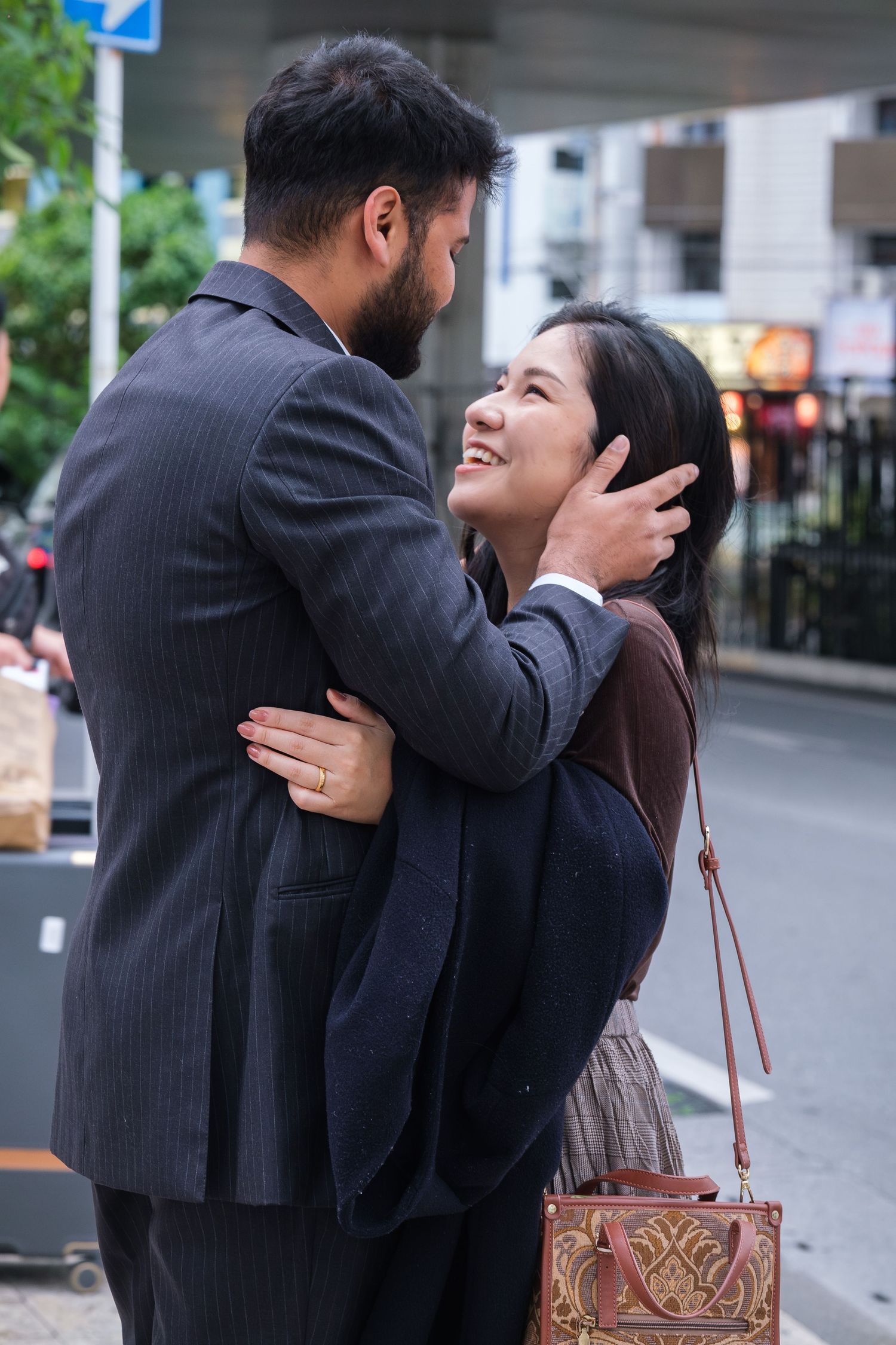 A romantic proposal moment captured on a city street corner as a couple shares a special moment together.