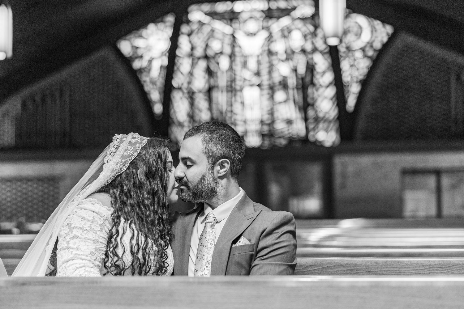 A black and white wedding photo collage showing intimate moments between a couple in an outdoor setting.
