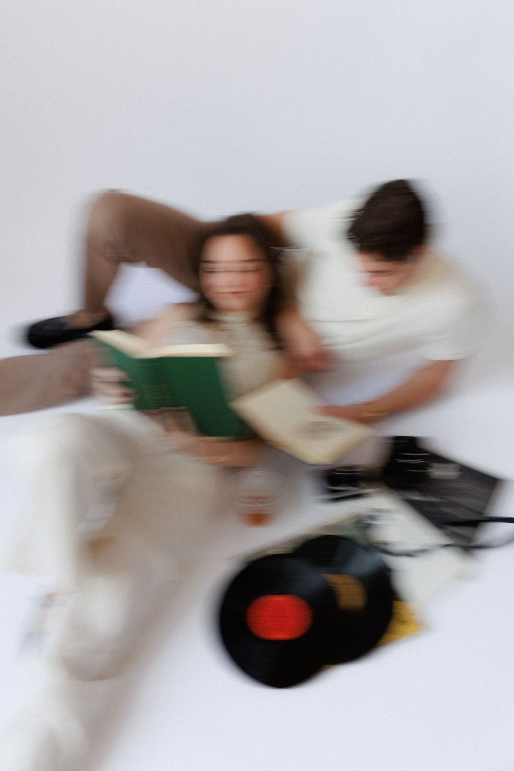 Motion blur captures a group studying together on a white couch, creating a dynamic and energetic scene.