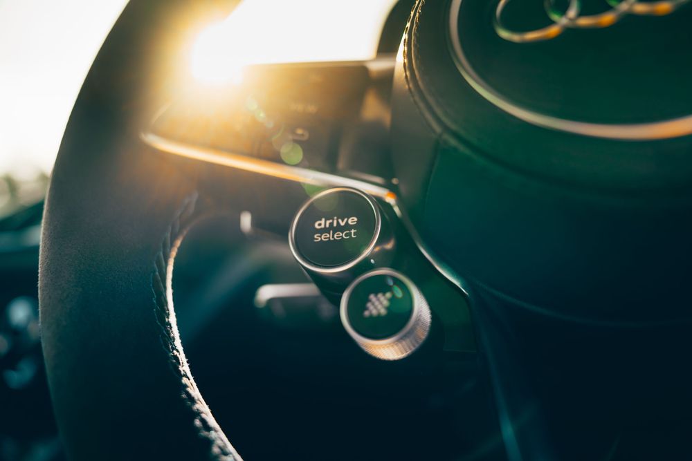 Close-up view of black audio headphones with metallic details in dramatic lighting.