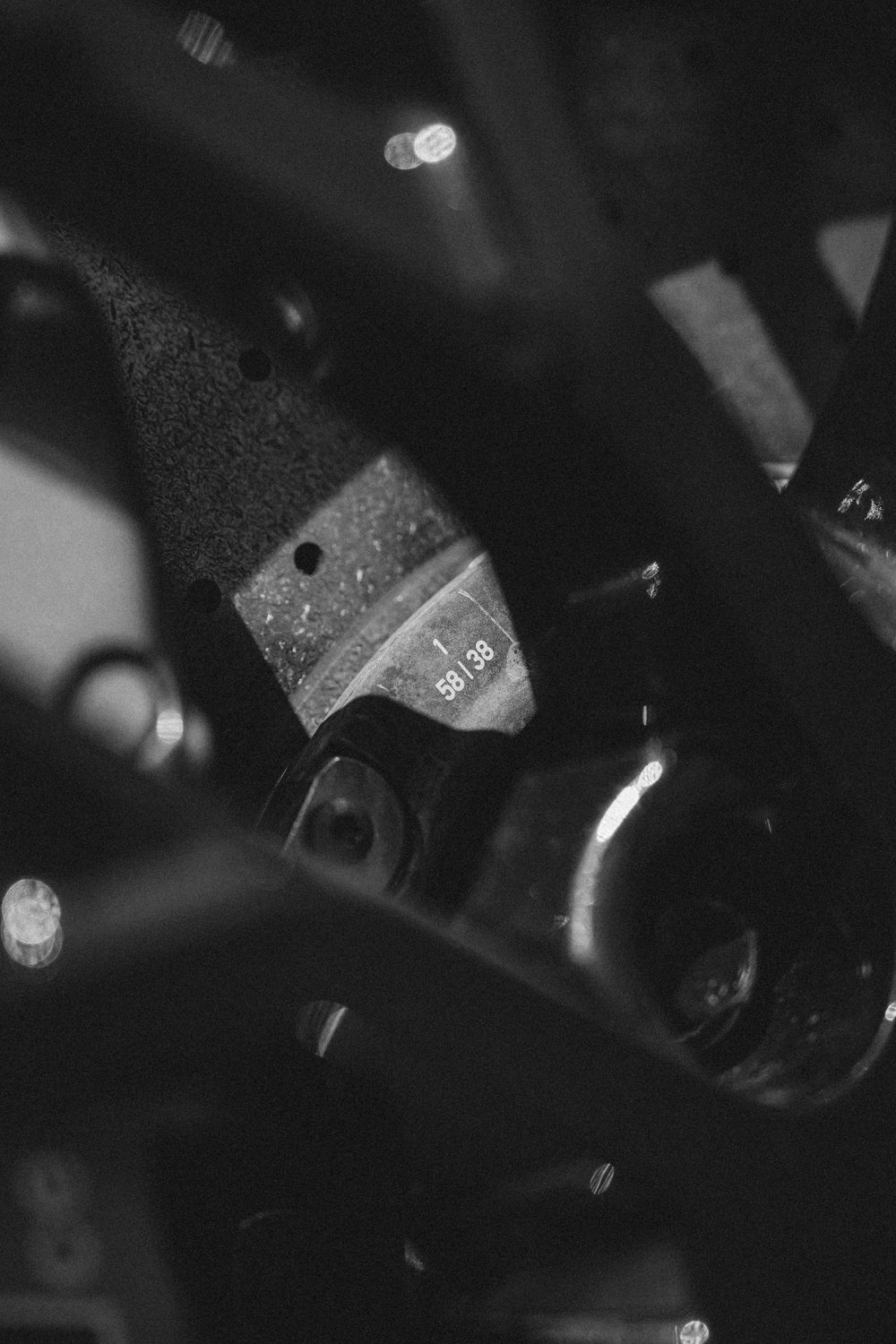 Dark macro shot of automotive mechanical components and controls in low light conditions.