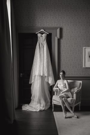 A black and white photo series showing a wedding dress displayed on a wall with a chair in a hotel room.