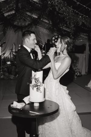 A couple shares a romantic dance sequence at their wedding reception, captured in a black and white photo series.