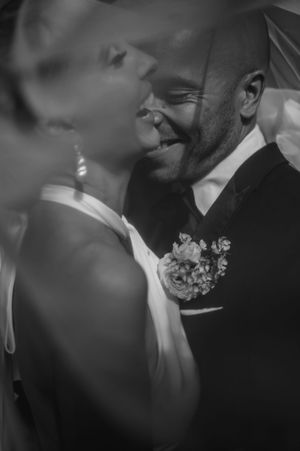 A romantic black and white wedding photo series showing intimate close-up moments between a couple.