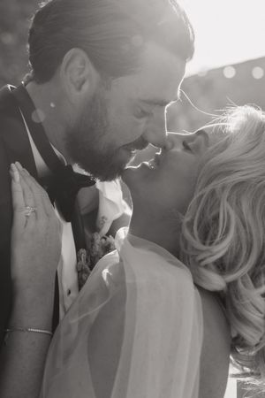A romantic black and white photo series showing an intimate couple embracing in soft sunlight.