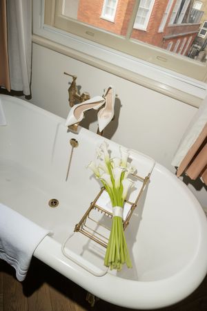Series of white clawfoot bathtub photos with green flower bouquet arrangements.