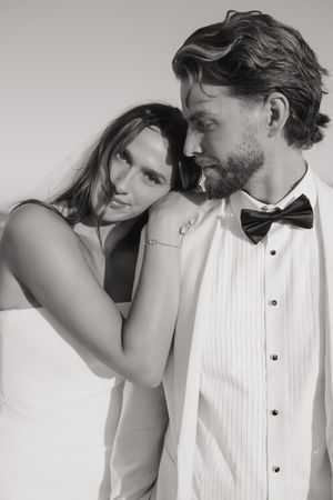 A romantic black and white photo sequence showing tender moments between a couple in formal attire.