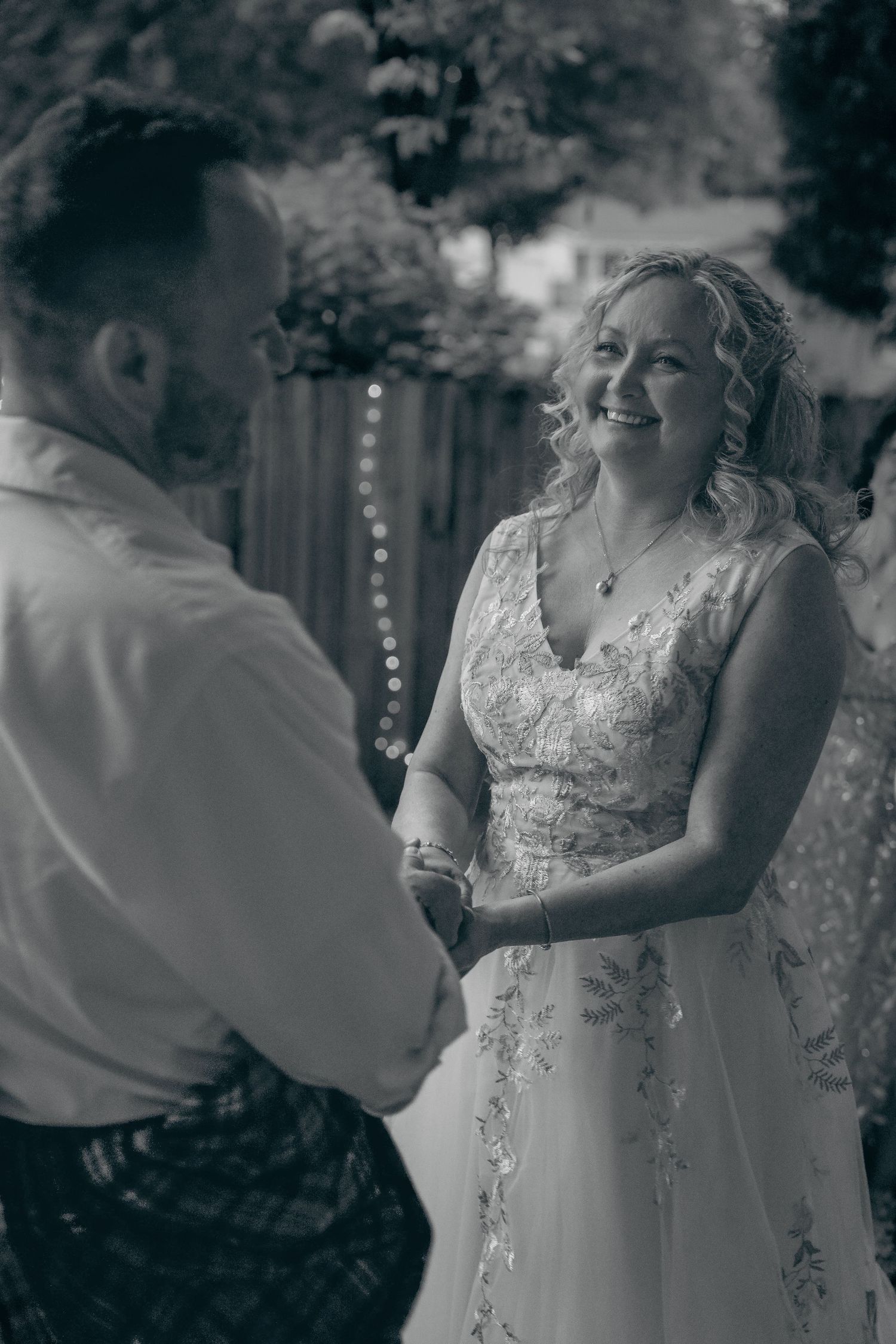 Black and white sequence showing a couple dancing together at an outdoor wedding reception.