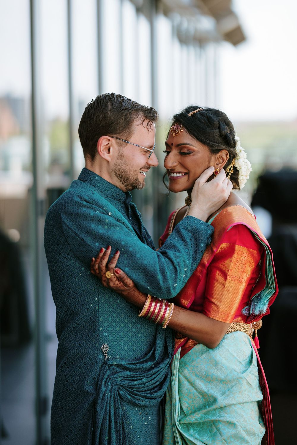A couple shares intimate moments in a series of romantic portraits against a bright window backdrop.