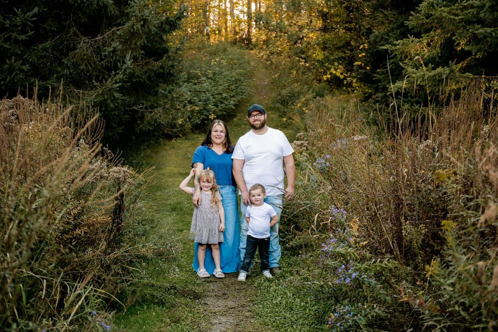 A series of outdoor family portraits captured in a lush wooded area during golden hour lighting.