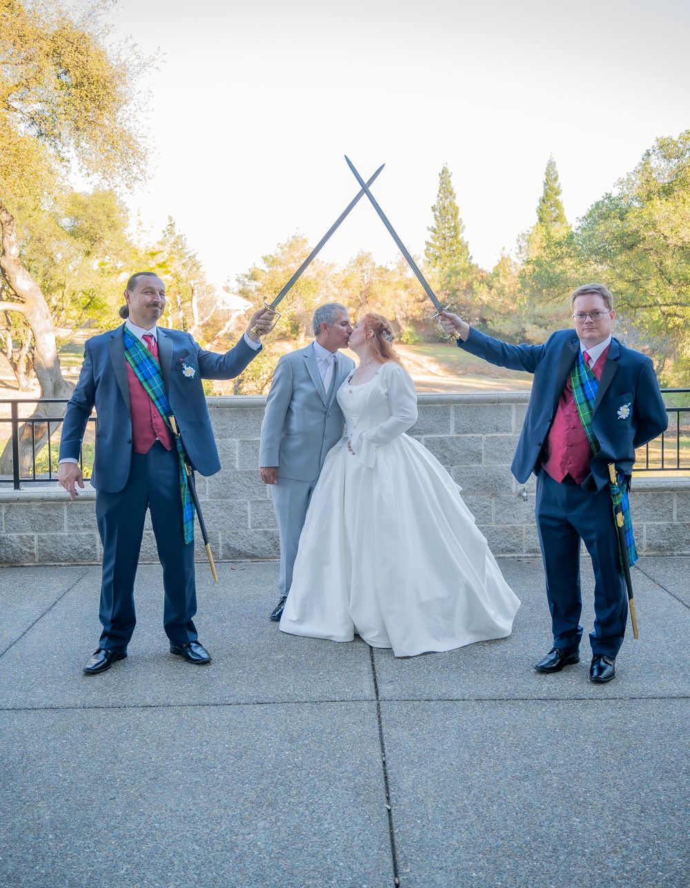 Wedding party members pose playfully with lightsabers in a series of outdoor celebration photos at sunset.
