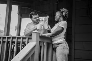 Black and white photo series showing intimate dance moments between two people on a porch.