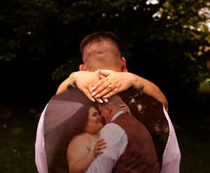 A romantic moment captured during an outdoor wedding photoshoot.