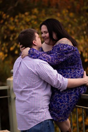 A couple shares an intimate moment in a romantic sequence of photos against an autumn backdrop.