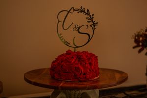 A sequence of images showing red roses being arranged into a dome shape on a cake, creating a beautiful floral decoration.