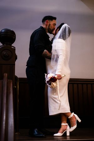 A romantic sequence of a couple in wedding attire sharing an intimate moment against a dark interior backdrop.